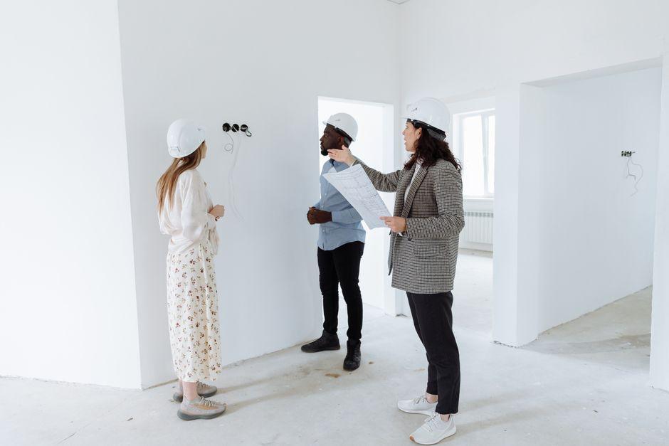 An Agent Showing the Interior of the House to the Buyers