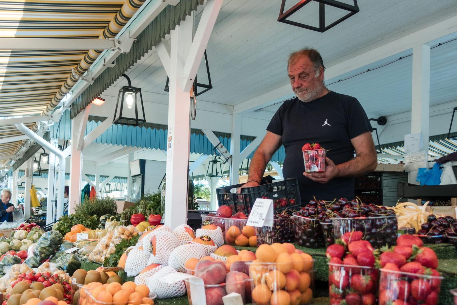 Man Selling Fruit at an Outdoor Market Stall